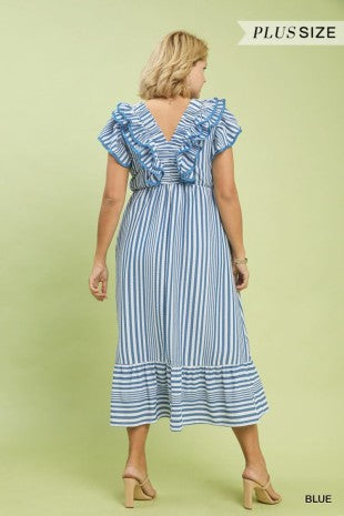 Woman wearing a blue and white striped dress on a light green background