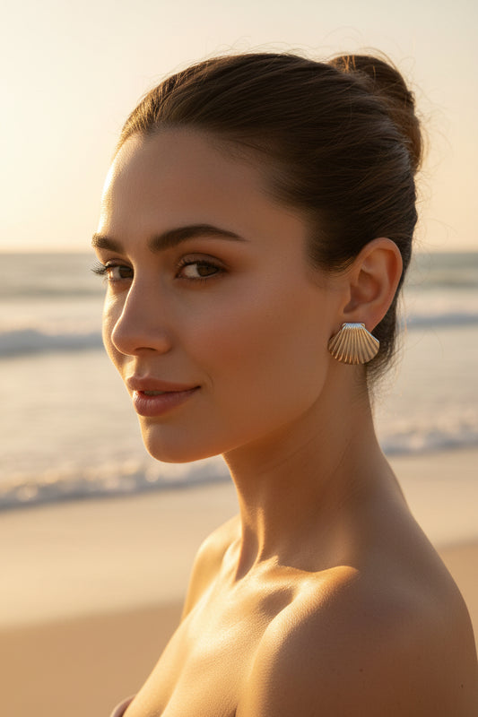 Pair of silver shell-shaped earrings in a textured box