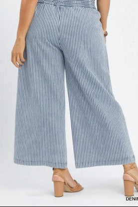 Blue and white striped wide-leg pants worn by a person on a white background