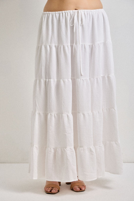 White tiered skirt worn by a person on a white background