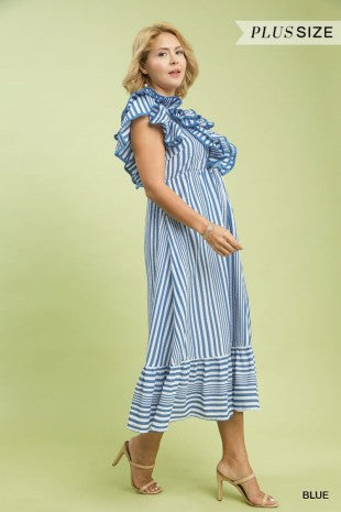 Woman wearing a blue and white striped dress on a light green background