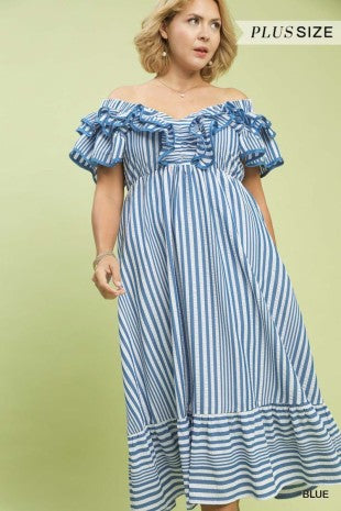 Woman wearing a blue and white striped off-shoulder dress on a light green background