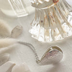 "Song Sung Blue" Floral Design Teardrop Locket Necklace in Silver